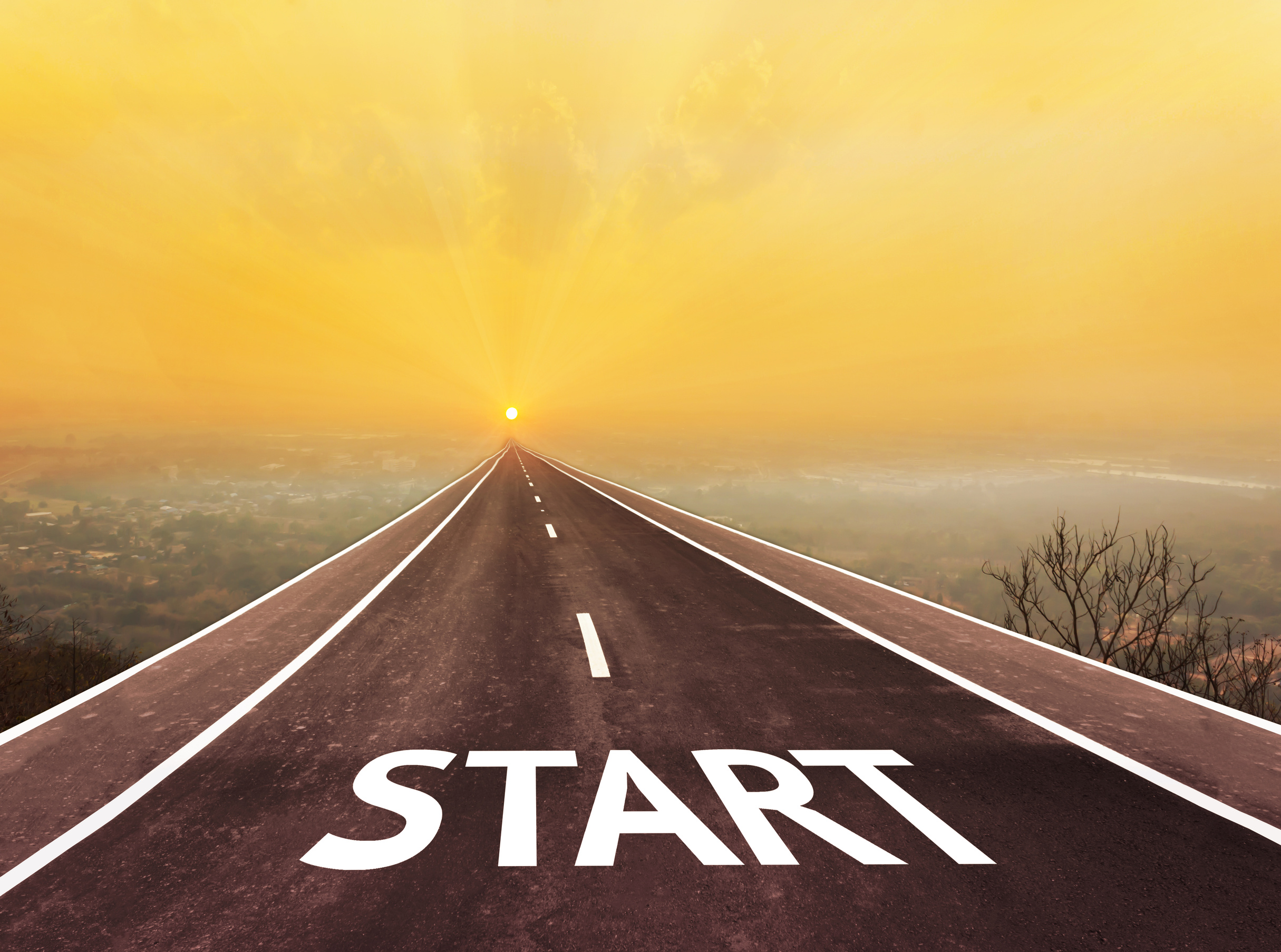 Long road with text start above blurred top city view